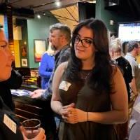 Three alums talking at the event.